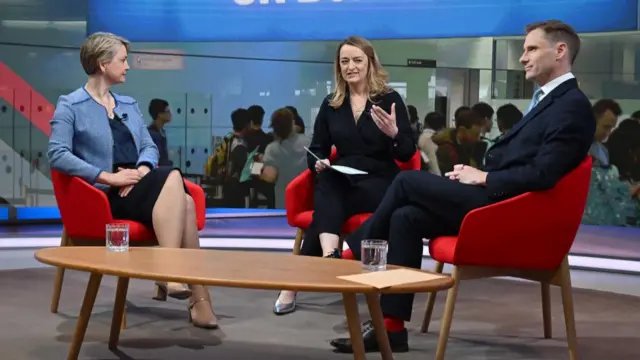 Sunday with Laura Kuenssberg TX 11/05/2025 - Yvette Cooper MP, Home Secretary (l) and Chris Philp MP, Shadow Home Secretary (r). They all are in formalwear and sit on chairs in the BBC studio.
