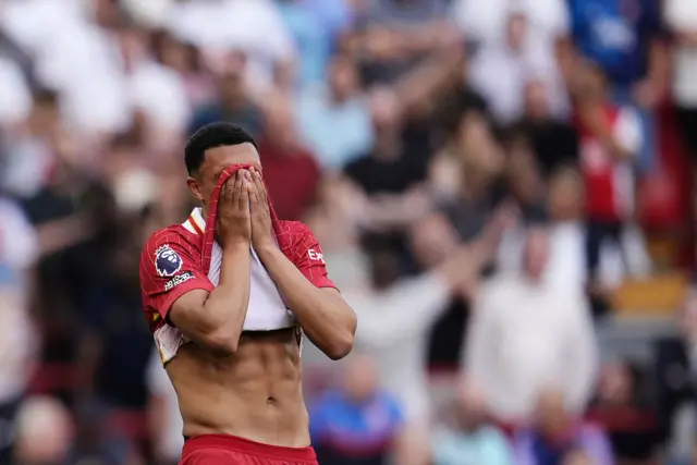 Liverpool's Trent Alexander-Arnold stands dejected.