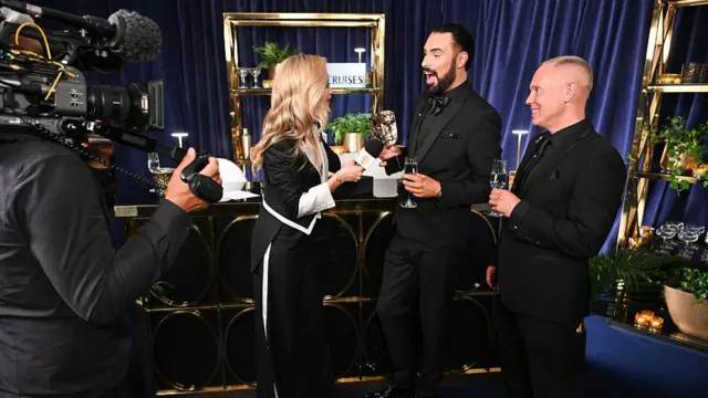 Rob Rinder and Raylan Clark being interviewed by Laura Whitmore