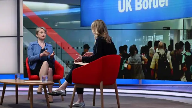 Cooper wears a blue jacket and speaks to Laura Kuenssberg in BBC studios.