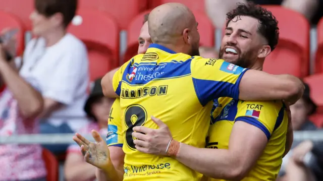 Warrington celebrate Toby King's try