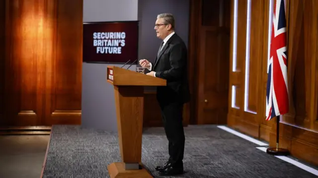 Starmer stands at a lectern as he delivers his speech
