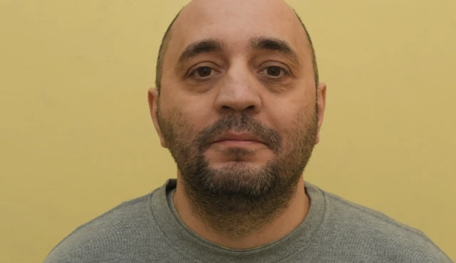 Mugshot of Bizer Dzhambazov in front of a yellow background