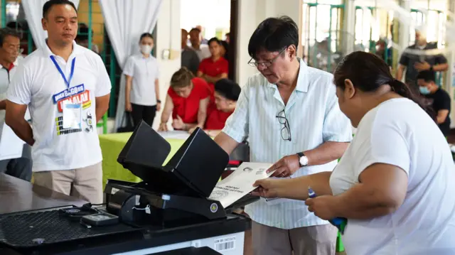 Marcos Jr puts his ballot into a voting machine