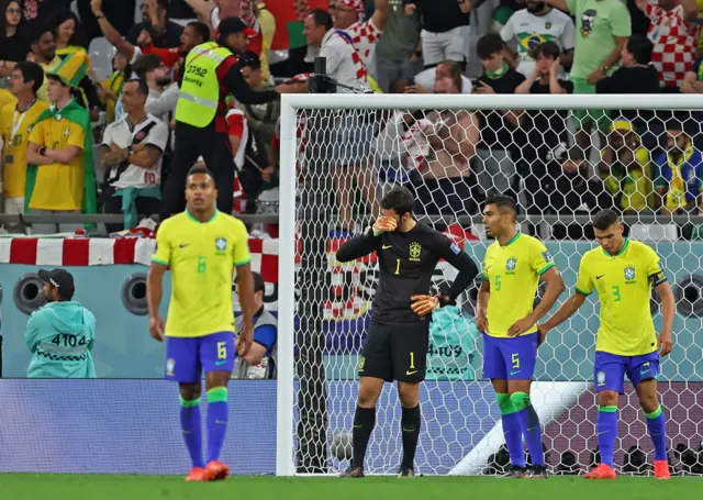 Goalkeeper Alisson Becker of Brazil (C) reacts in Qatar