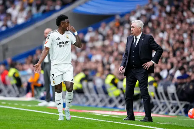 Vinicius Junior of Real Madrid talks to Carlo Ancelotti
