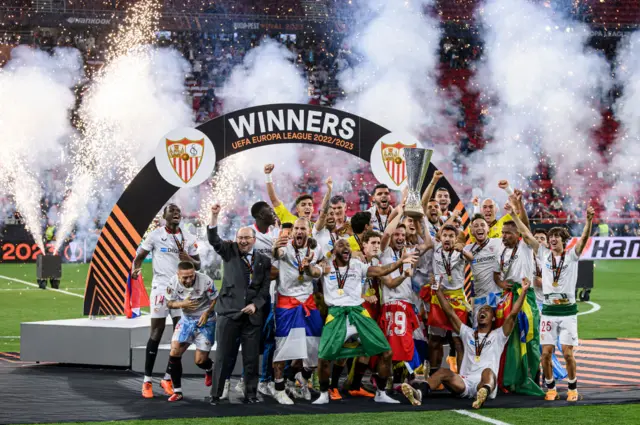 Ivan Rakitic and Jesus Navas of Sevilla FC lift the trophy