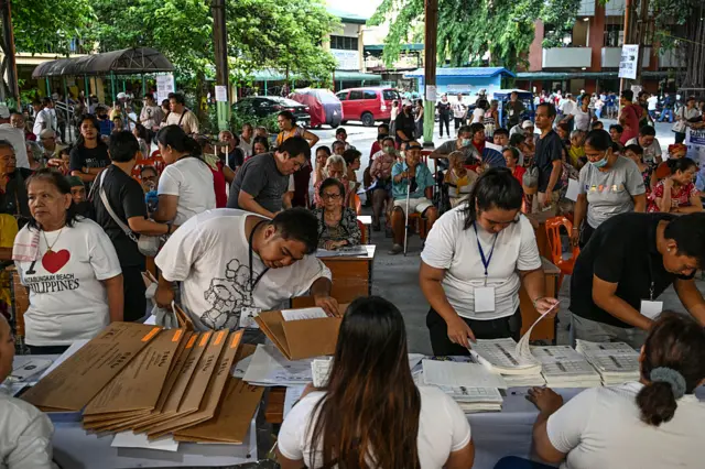 People prepare to vote at a busy polling station in Manila, Philippines.