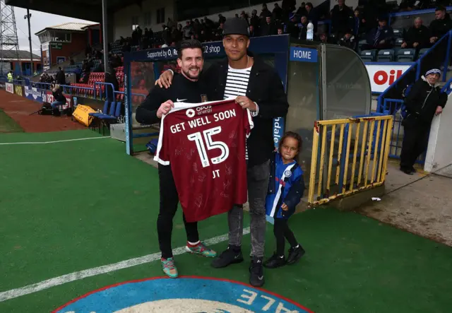 David Buchanan of Northampton Town presents a signed Northampton Town shirt to Rochdale's Joe Thompson before their match in April 2017. It was a show of solidarity with Thompson following his second cancer diagnosis