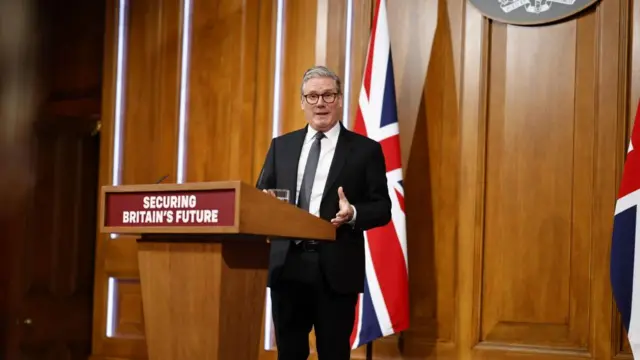 Starmer behind a podium.