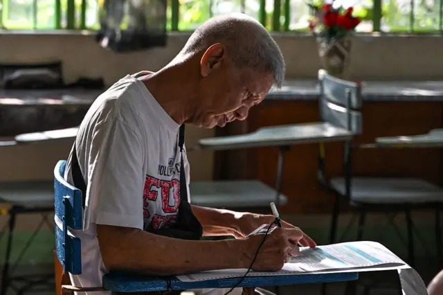 A man votes at a polling station in the Philippines.