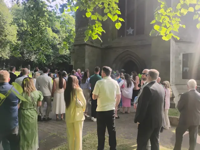 Mourners arrive at Joe Thompson's funeral