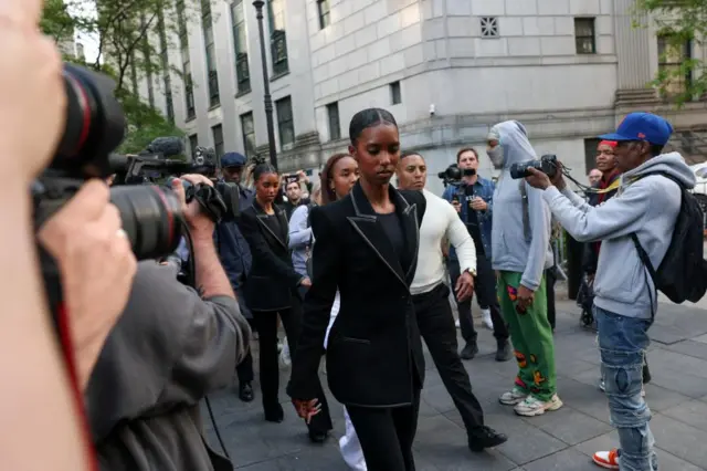Sombre woman walks out of court