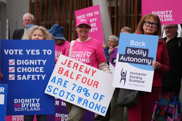 Members of Dignity in Dying Scotland and members of the Assisted Dying Coalition as they show their support for a change in the law on assisted dying outside the Scottish Parliament in Edinburgh, ahead of the debate and vote on the Assisted Dying for Terminally Ill Adults (Scotland) Bill later today.