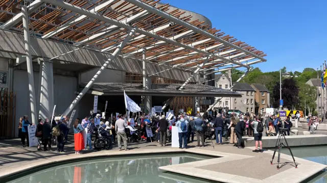 demonstrators outside the Scottish Parliament building