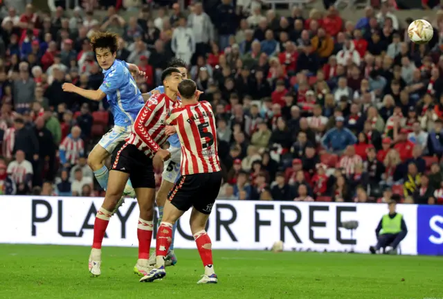 Coventry City's Tatsuhiro Sakamoto heads at goal