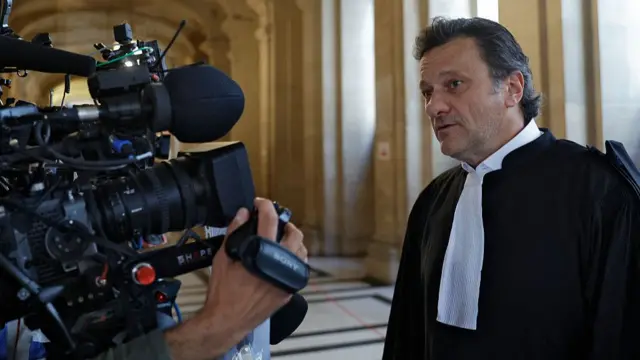 A man speaking to a big camera