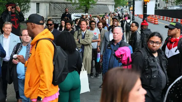 People wait to enter Manhattan Federal Court for the trial of Sean "Diddy" Combs on May 13, 202