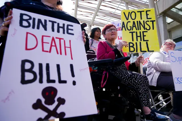 Protesters from the Glasgow Disability Alliance demonstrating outside the Scottish Parliament in Edinburgh, ahead of the debate and vote on the Assisted Dying for Terminally Ill Adults (Scotland) Bill later today. Picture date: Tuesday May 13, 2025. PA Photo. See PA story POLITICS AssistedDying.