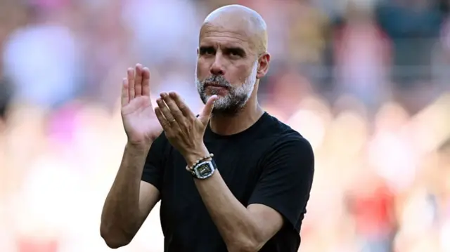 Pep Guardiola, manager of Manchester City, acknowledges the fans