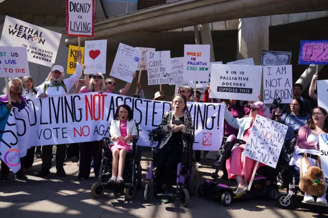Actress Liz Carr (right) and Pam Duncan-Glancy MSP with members of the Glasgow Disability Alliance, demonstrating outside the Scottish Parliament in Edinburgh.