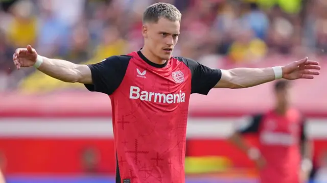 : Florian Wirtz of Bayer 04 Leverkusen gestures during a Bundesliga match