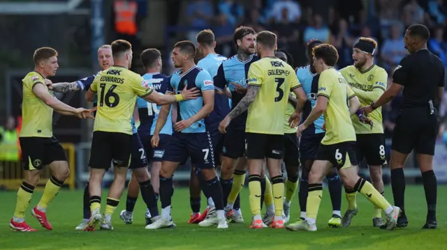 Wycombe and Charlton players confront each other in the first leg