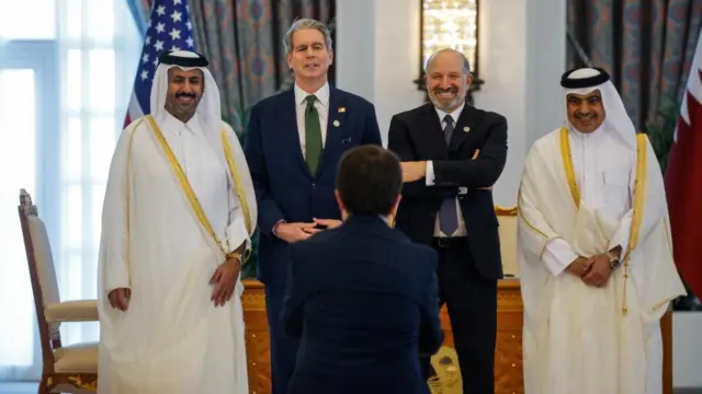 US Secretary of the Treasury Scott Bessent and Secretary of Commerce Howard Lutnick pose for a picture with Qatari officials