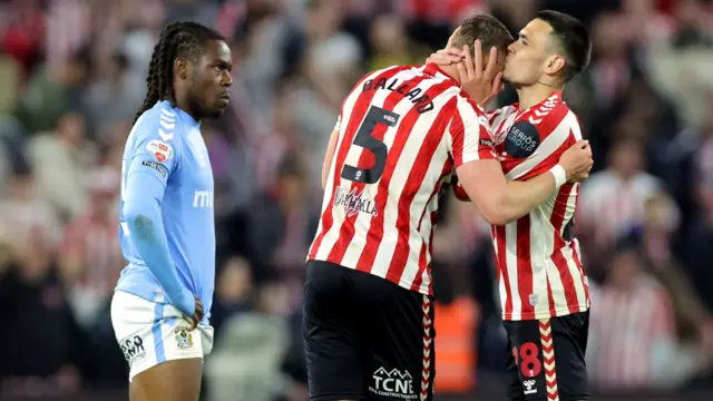 Enzo Le Fee kisses Dan Ballard's forehead
