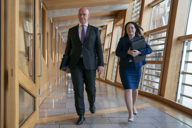 First Minister of Scotland John Swinney and Deputy First Minister Kate Forbes arrive for First Minister's Questions at the Scottish Parliament in Holyrood, Edinburgh