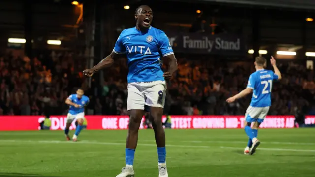 Isaac Olaofe of Stockport County celebrates scoring to make it 1-1