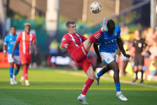 Leyton Orient's Ethan Galbraith (left) catches Stockport County's Isaac Olaofe with a high boot