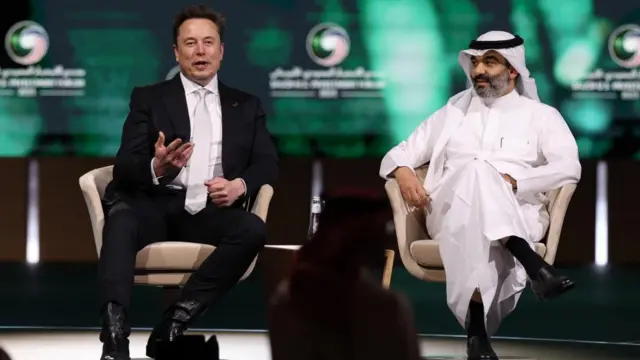 Musk and Alswaha sitting on stage together