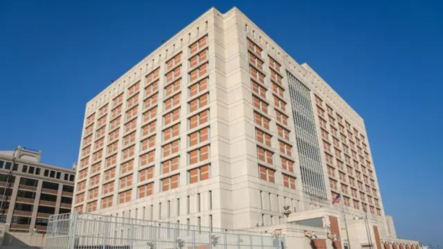 The outside of a tall, cube-shaped prison called thee Metropolitan Detention Centre