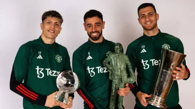 Alejandro Garnacho, Bruno Fernandes and Diogo Dalot of Manchester United pose with their club awards for the 2024 season