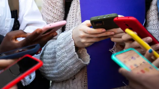 A group of young people using their mobile phones