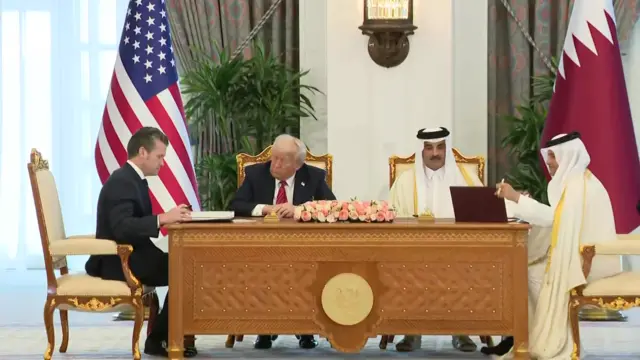 Pete Hegseth sits next to Donald Trump as a joint declaration is signed in Doha