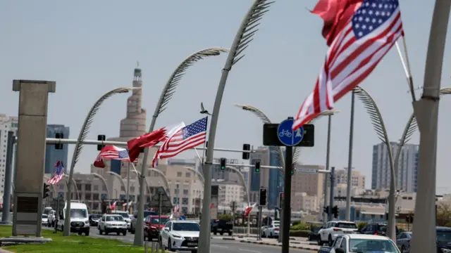 US and Qatari flags are seen on lampposts in Doha ahead of Donald Trump's visit