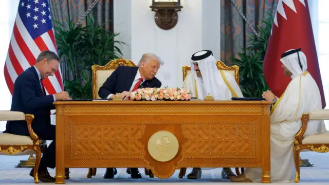 U.S. President Donald Trump, Qatar's Emir Tamim bin Hamad Al Thani and Boeing CEO Kelly Ortberg attend a signing ceremony in Doha, Qatar