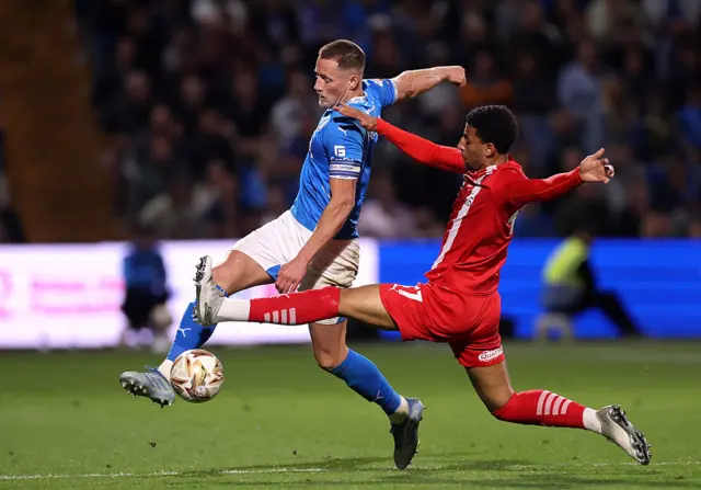 Fraser Horsfall of Stockport County is challenged by Azeem Abdulai of Leyton Orient
