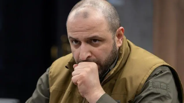 Rustem Umerov wearing a dark green jacket and beige waistcoat