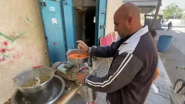 A man grinds items into flour