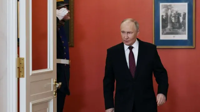 Russian President Vladimir Putin arrives to make a statement to the media at the Kremlin in Moscow