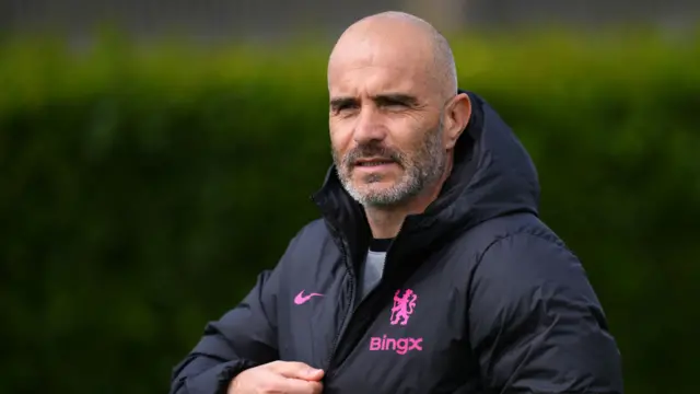 Manager Enzo Maresca zips his jacket at Chelsea training
