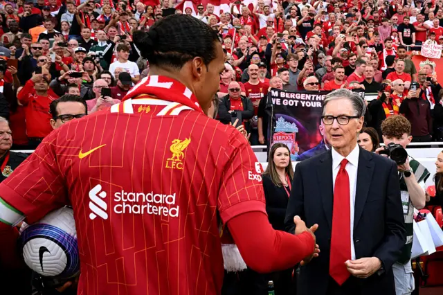 Liverpool's Principle Owner John Henry interacts with Virgil van Dijk