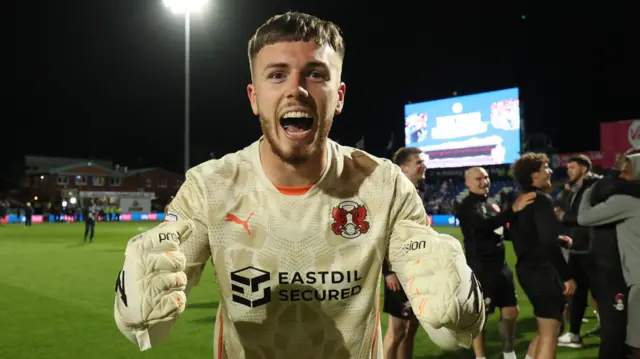 Leyton Orient goalkeeper Josh Keeley celebrating their win over Stockport