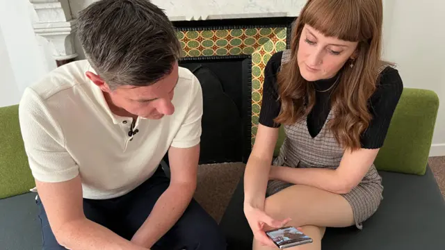 Reporters Andy Howard and Harriet Robinson sat down looking at their phones