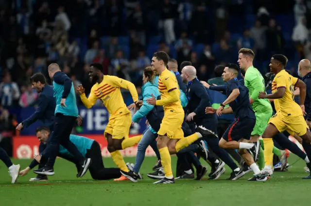 Fans storm pitch