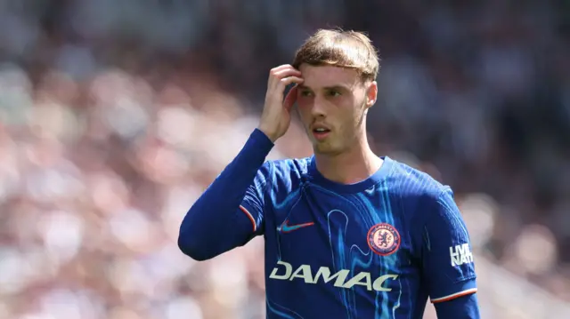 Cole Palmer scratches his head while playing for Chelsea