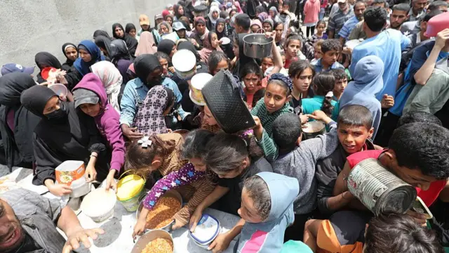A crowd gathering at a food distribution point in Gaza